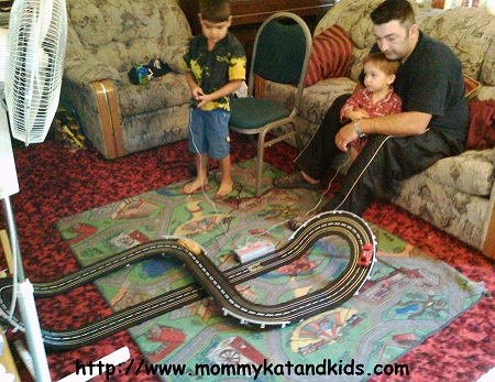 Curtis, Zack and Ben Lavallee playing with slot cars