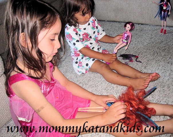 girls playing with winx club dolls