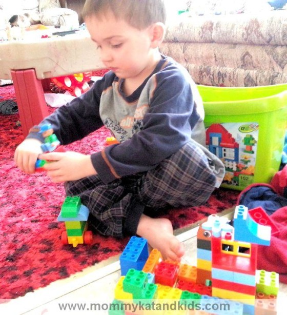 boy playing with lego duplo blocks