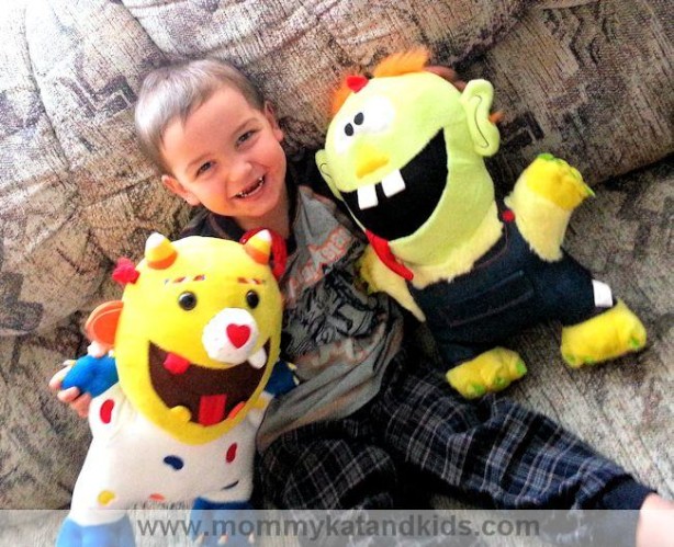 boy smiling goofy grin monster toys