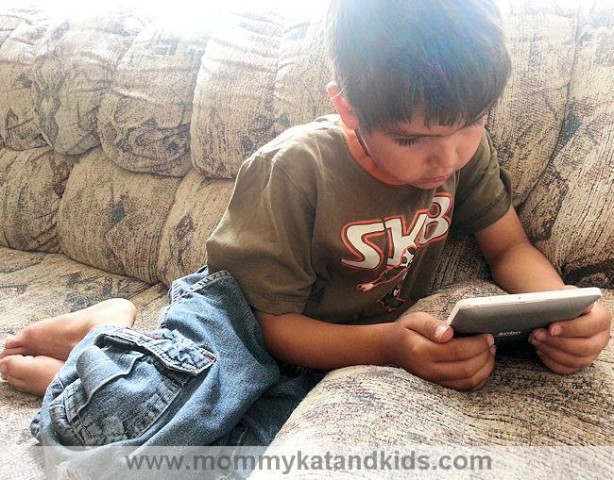 boy reading kobo mini ereader