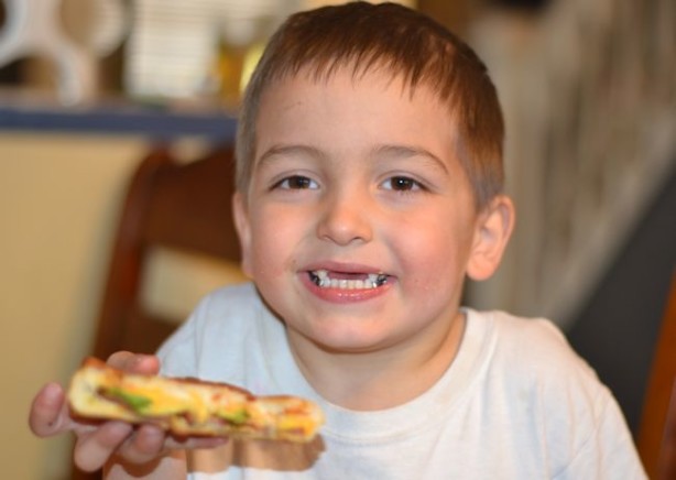 boy eating grilled cheese sandwich