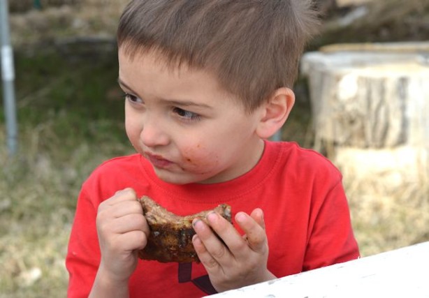 boy eating ribs