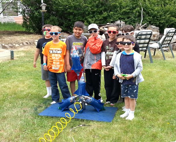 boys at water bottle rocket launch pad