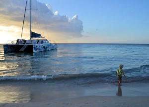 boy and catamaran ocean jamaica