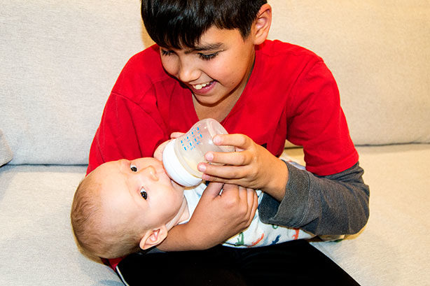 boy-bottlefeeding-baby
