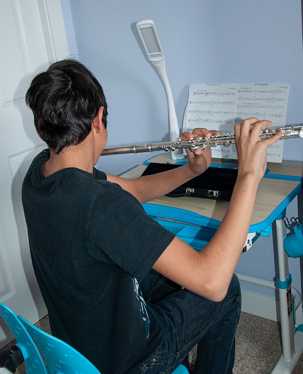 boy-practicing-flute-at-desk