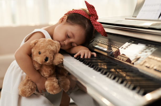 child-sleeping-at-piano
