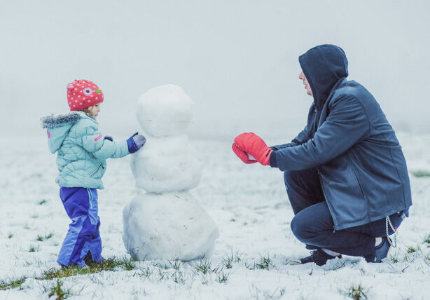 dad-and-daughter-building-snowman