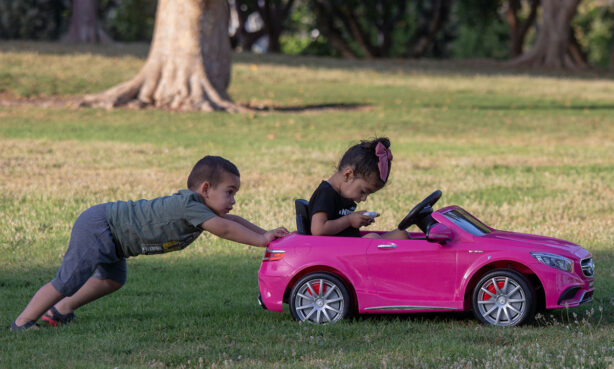 boy-pushing-girl-in-toy-car