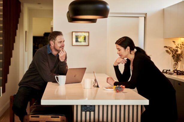 man and woman working at counter