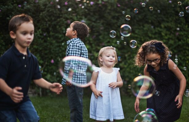 kids in backyard with bubbles