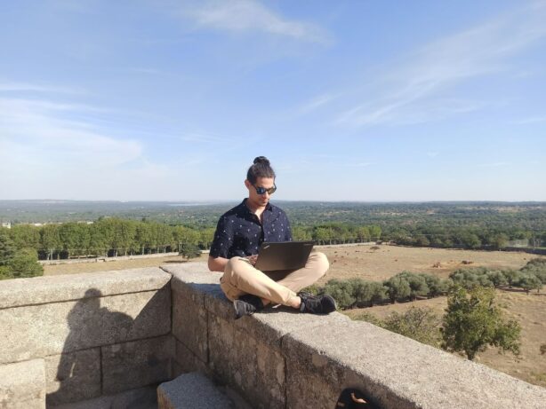 digital nomad working on stone wall in spa