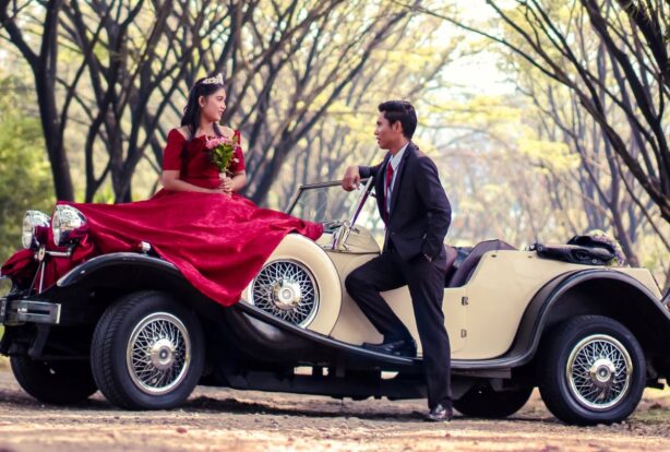 couple with classic car and formal clothes