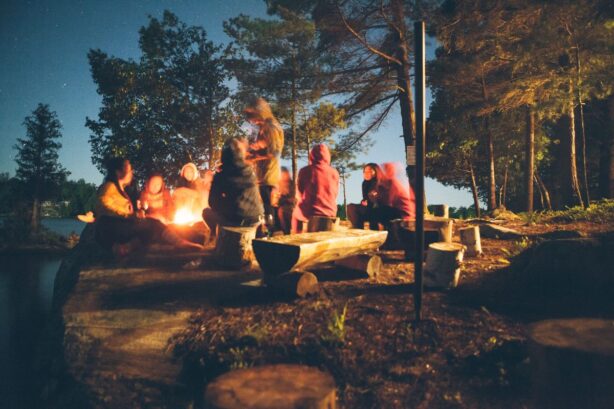 group of people around campfire