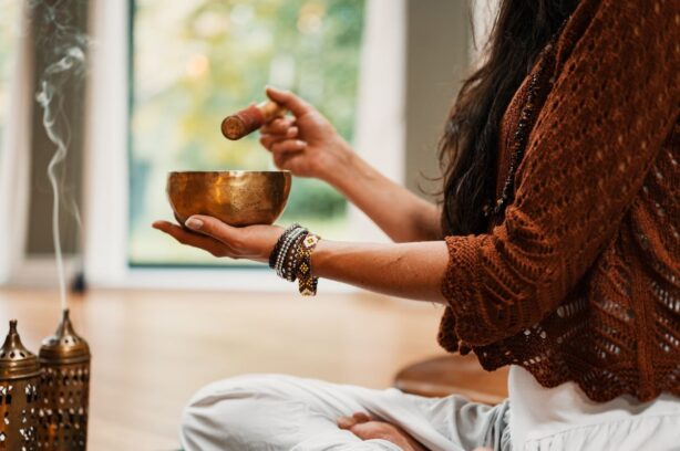 woman with incense and healing bowls