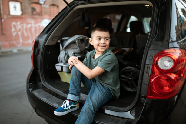 boy in back of car