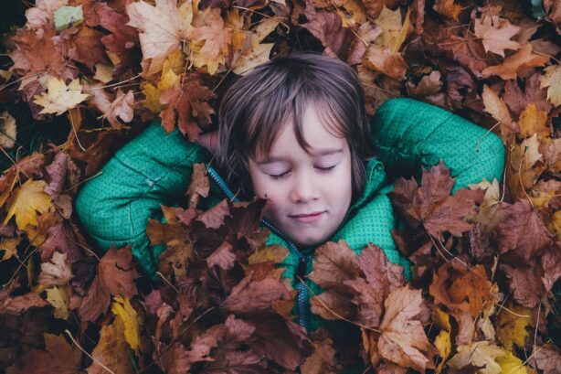 boy relaxing in leaves