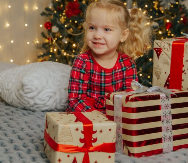 girl with presents in front of t