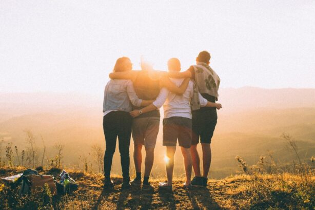 group hugging on a hillside