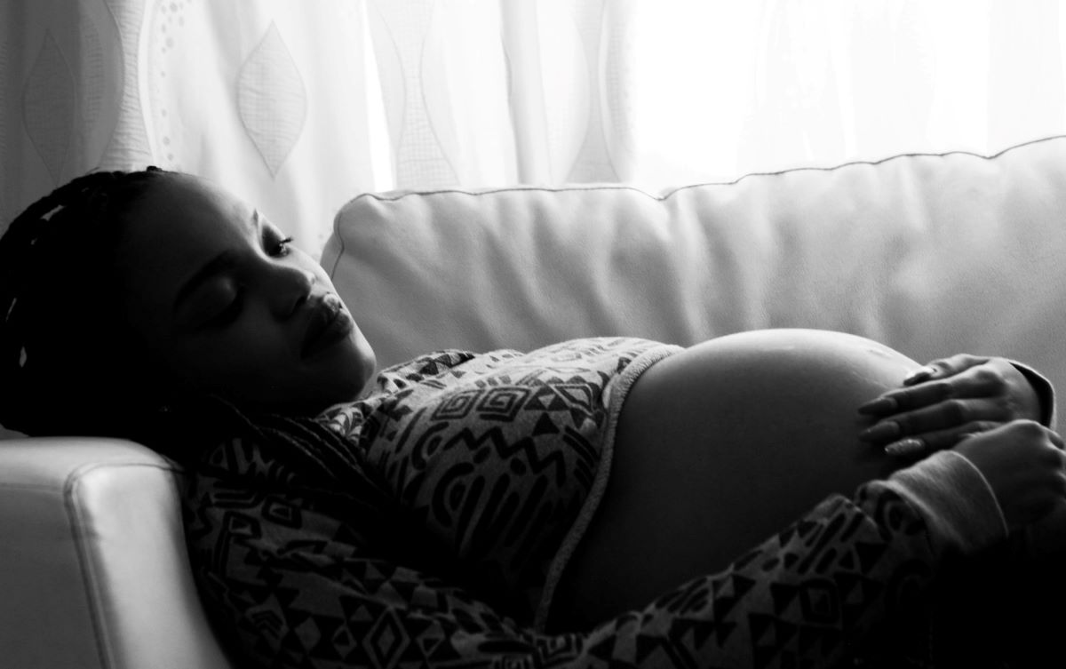 pregnant woman resting on couch