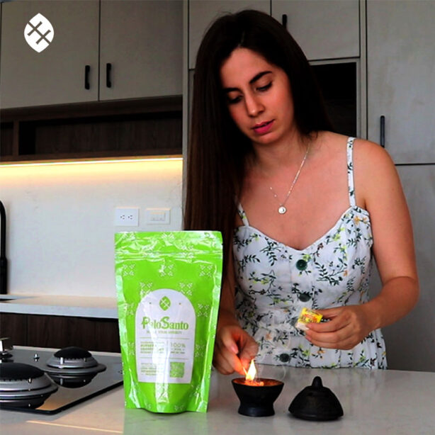 woman lighting palo santo incense