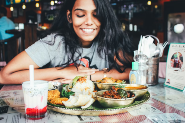 woman looking at plated food
