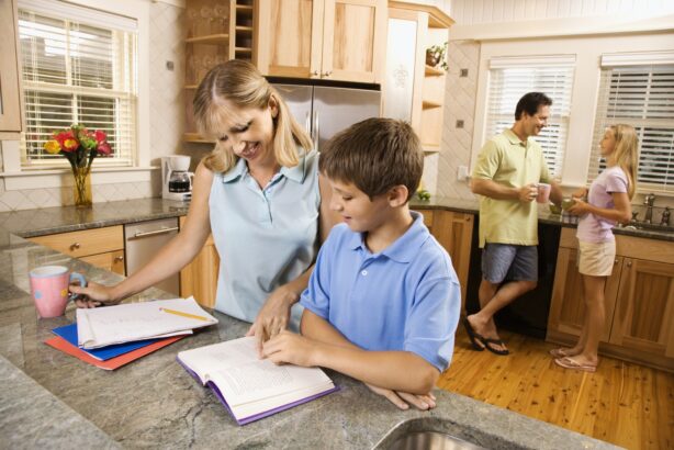 family in kitchen doing homework